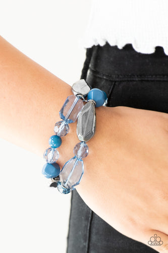 Mismatched gunmetal, polished blue, and crystal-like beads are threaded along interlocking stretchy bands for a whimsical look.