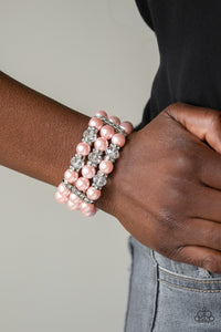 Paparazzi - Undeniably Dapper - Pink Bracelet - Pinched between white rhinestone encrusted frames, white rhinestone encrusted rings, crystal-beads, and pink pearls are threaded along elastic stretchy bands for a glamorous look.  Paparazzi Jewelry and accessories are lead-free and nickel-free.  Sold as one individual bracelet.
