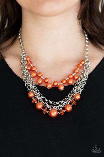 Orange pearls, orange crystal-like beads, and faceted silver beads .  Necklace with Clasp Closure.