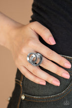 Load image into Gallery viewer, Paparazzi  - Pro Top Spin - Black Ring - Paparazzi Accessories A pair of beveled gunmetal rings asymmetrically interlock atop the finger, creating a dizzying centerpiece.
