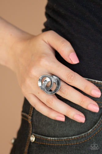 Paparazzi  - Pro Top Spin - Black Ring - Paparazzi Accessories A pair of beveled gunmetal rings asymmetrically interlock atop the finger, creating a dizzying centerpiece.