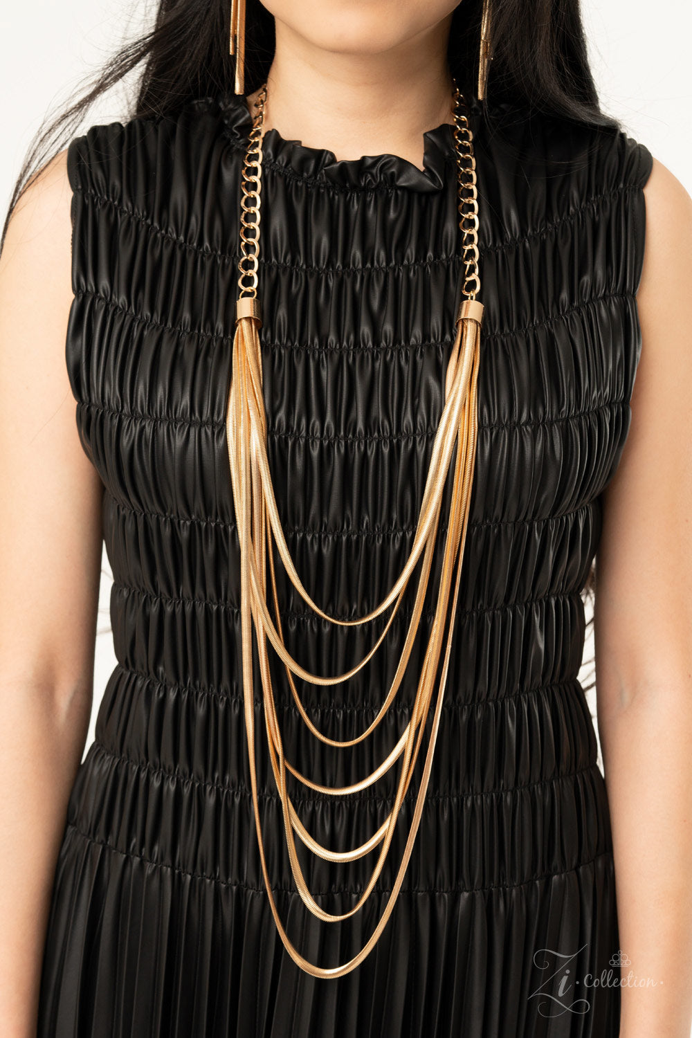 Paparazzi  - Commanding Zi Collection Necklace 2020 - Paparazzi Accessories  bold fittings, lengthened rows of gold herringbone chains layer flawlessly together across the chest. The sleek display attaches to strands of over-sized gold links, adding a gritty industrial edge to this majestic masterpiece. 