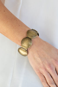Brass Bracelet Infused with curved bar-like accents, an antiqued series of beveled brass discs are threaded along stretchy bands around the wrist for a bubbly metallic look.  Paparazzi jewelry is lead and Nickel-free