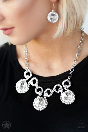 Three over-sized  white rhinestones on a silver Necklace- Paparazzi Accessories  Three dramatically over-sized rhinestones are nestled into textured silver fittings that are connected by oval silver frames, creating a brilliant statement piece.  Features an adjustable clasp closure.