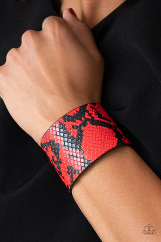 The Rest is Hiss-tory -Red  Bracelet - Featuring a red python print, a thick black leather band wraps around the wrist for a wild look. Features an adjustable snap closure.  Paparazzi accessories are all lead free and nickel free.  Fashion Fabulous Jewelry.  Sold as one individual bracelet.  P9SE-RDXX-184XX