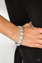 Load image into Gallery viewer, Number One Knockout  White Rhinestone Bracelet - Paparazzi Accessories - Paparazzi Accessories Faceted white gems are pressed into sleek silver frames.  The glittery frames are threaded along elastic stretchy bands, creating a glamorous look around the wrist.  